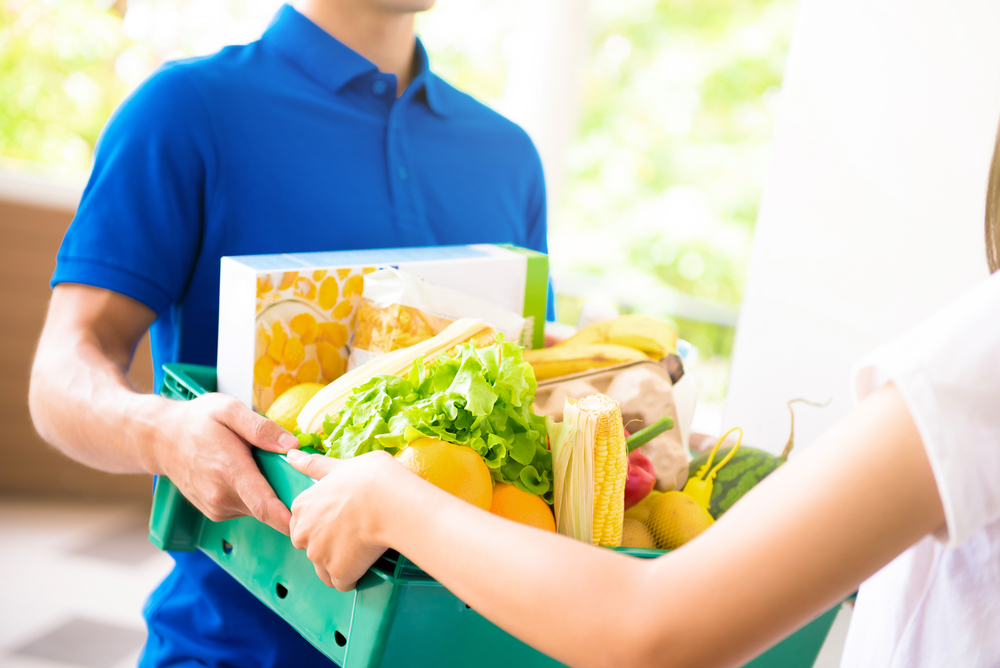 Image of a woman receiving a grocery delivery